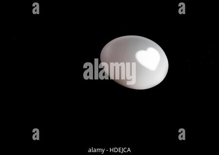 shadow of the eggs and the projection on his heart, abstract, black and white. Stock Photo