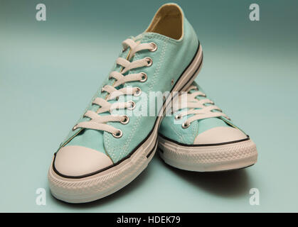 Turquoise sneakers on a blue background Stock Photo