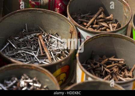 Nails in rusty tin can on a wooden background Stock Photo