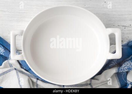 Empty ceramic pan on the white wooden table top view Stock Photo