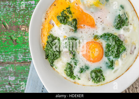 Florentine eggs with pureed spinach on the wooden table Stock Photo