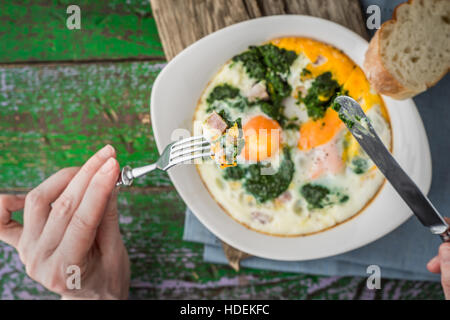 Eating Florentine eggs with purred spinach horizontal Stock Photo