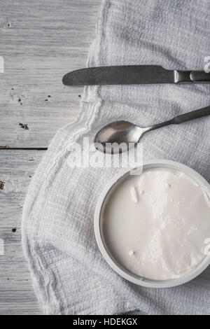 Ricotta with cutlery and napkin on the white wooden table vertical Stock Photo