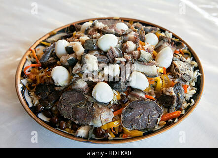 Uzbek national dish pilaf on a plate in a Bukhara restaurant Stock Photo