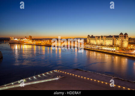 Evening view of the house on the city's waterfront, illuminated by night lights in Oslo, Norway. Stock Photo