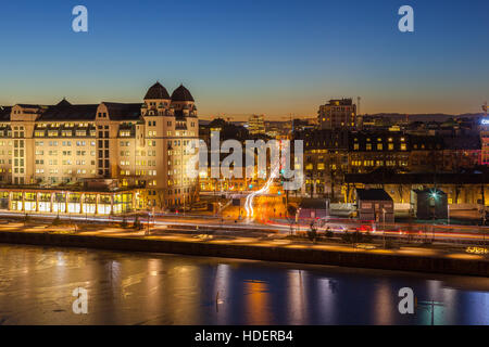 Evening view of the house and traffic on the city's waterfront, illuminated by night lights in Oslo, Norway. Stock Photo