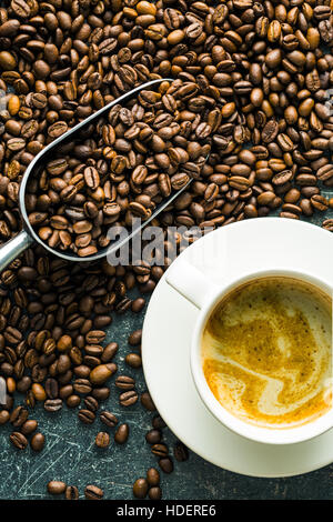 Roasted coffee beans and cup of coffee. Stock Photo