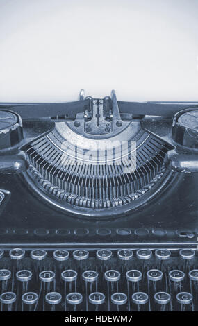 Old typewriter and blank sheet of paper for your text, cyan style Stock Photo