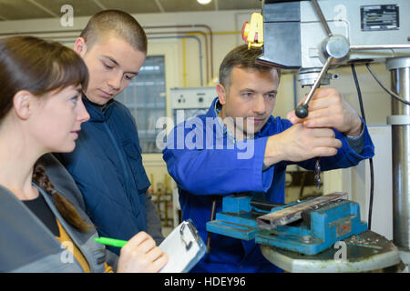 apprentices working on the machine - metal processing Stock Photo