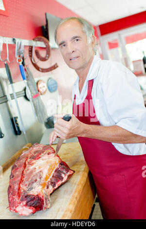 Butcher cutting meat Stock Photo