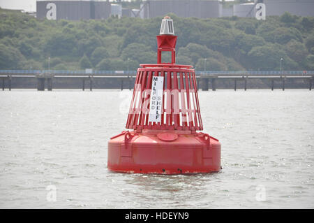 Milford Shelf port navigation buoy with oil terminal jetty behind. Stock Photo