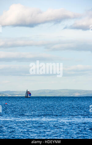 Dinghy sailing in Carmarthern Bay off Tenby on a beautiful summers day. Stock Photo