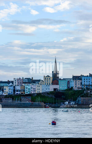 A cool blue Tenby on a calm summers evening with masts visible over the harbour wall. Stock Photo