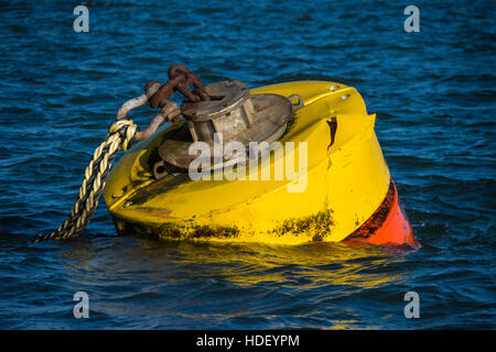 Massive mooring rope on a tug mooring buoy in blue rippled water in Milford Haven Stock Photo