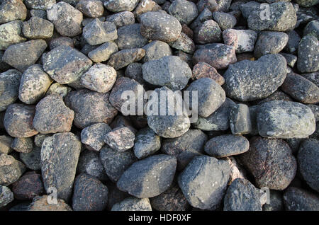 Old weathered gray cobble stones in a heap Stock Photo