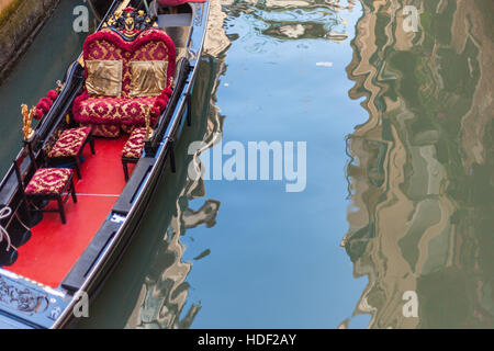 A Gondola boat is waiting on a Venetian Canal for tourists Stock Photo