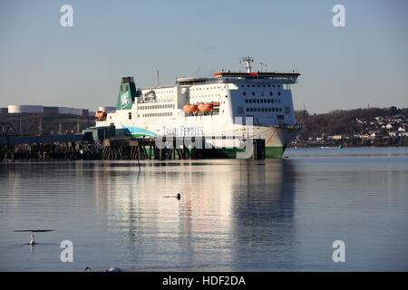 The white green and blue painted Isle of Inishmore berthed at a dock getting ready to sail on a sunny day in placid waters. Stock Photo