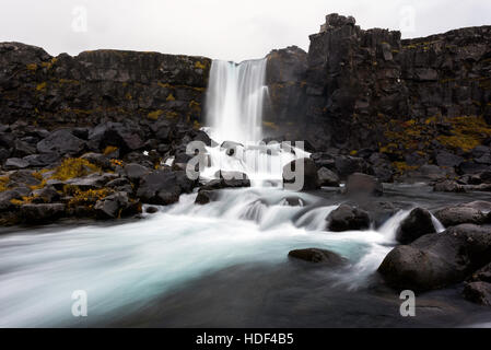 Oxararfoss is a waterfall in Þingvellir National Park, Iceland. It flows from the river Oxara over the Almannagja. Stock Photo