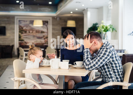 Little girl doesn't want to hear arguing of parents Stock Photo