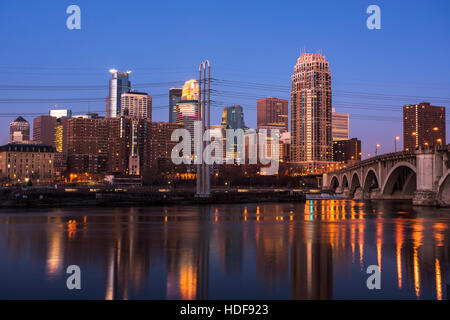 Minneapolis skyline at dawn with the Mississippi River in the foreground. Stock Photo