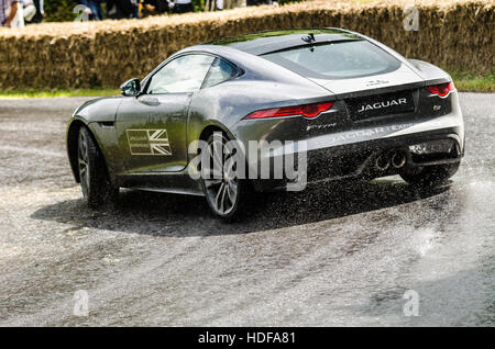 Jaguar F Type S carrying out driving experiences at the Goodwood Festival of Speed 2016 including power slides in the wet Stock Photo