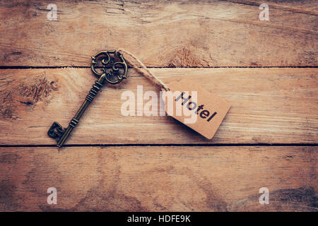 Business concept - Old key vintage on wood with tag Hotel. Stock Photo
