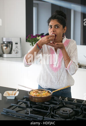 Young Indian woman in a kitchen preparing ayurvedic food Stock Photo