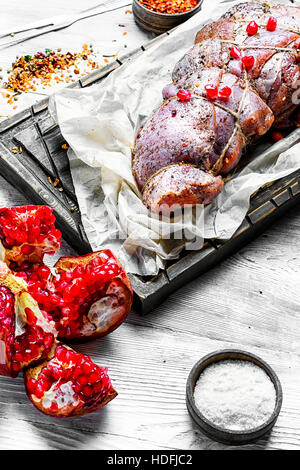 Meat knuckle ,soaked in pomegranate sauce and spices Stock Photo