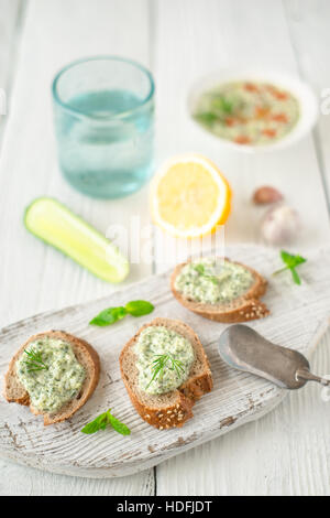 Bread with tzatziki on the white wooden table vertical Stock Photo