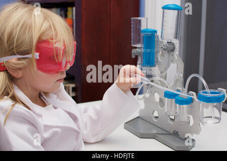adorable school age girl working with science kit for S.T.E.M. or STEM Stock Photo