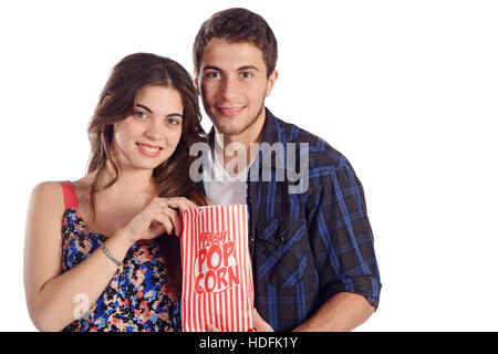 Portrait of a young beautiful couple eating popcorn and watching movies. Isolated white background. Stock Photo