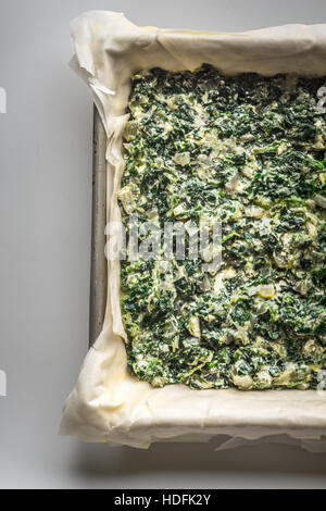 Raw Greek pie Spanakopita vertical Stock Photo