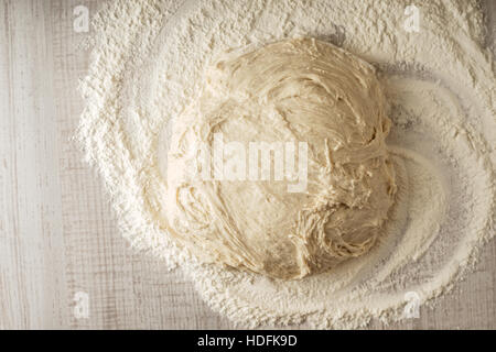 Dough on the table with flour top view Stock Photo