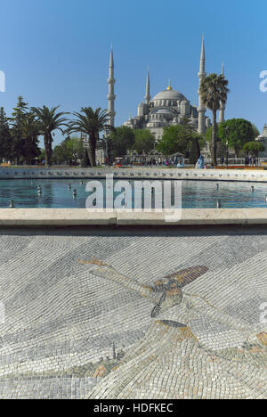 Istanbul, Turkey with the Hagia Sophia in the background and a fountain surrounded by a mosaic whirling dervish in the fore. Stock Photo