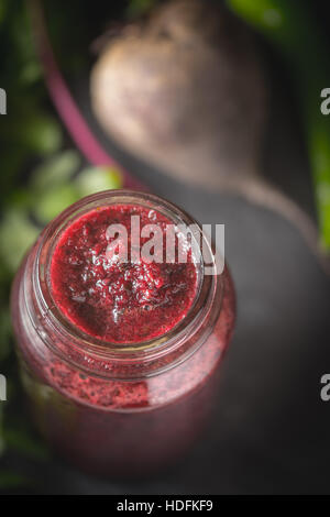 Vegetable smoothie with blurred ingredients on the dark stone background Stock Photo