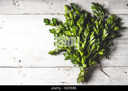 Bunch of parsley on the white wooden table horizontal Stock Photo
