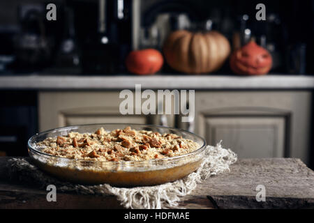 Raw pumpkin dump cake in the baking dish on the wooden table Stock Photo