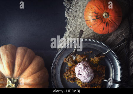 Pumpkin dump cake with ice cream on the metal plate on the stone table horizontal Stock Photo