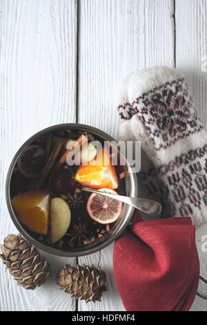 Pot with mulled whine on the white wooden table top view Stock Photo