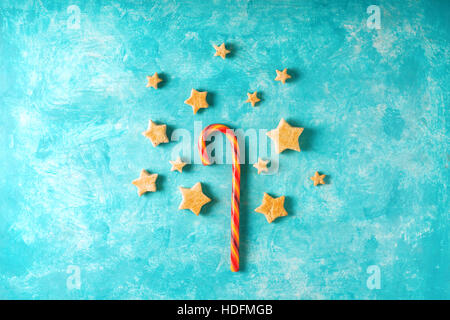 Christmas candy and cookies on the blue background top view Stock Photo