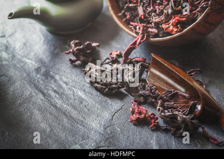 Set for hibiscus tea  preparation on the dark stone table Stock Photo