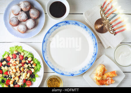 Traditional Hanukkah  dishes on the white wooden table top view Stock Photo