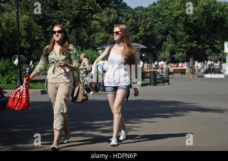 Russian girls walking in Gorky Park, with a purse and a volleyball. Moscow, Russia Stock Photo