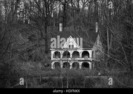 An abandoned house tagged with graffiti sits in the woods adjacent the Thames River in Southwestern Ontario Canada. Stock Photo