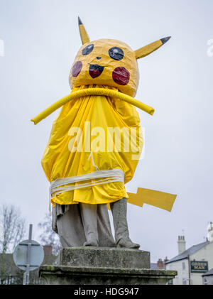 Dunchurch, Warwickshire, England. 12th December 2016. The statue of Lord John Scott in the village of Dunchurch has been covered in the disguise of Pokemon character Pikachu. In a tradition spanning decades, a secretive group of villagers dress the statue annually on the run-up to Christmas. The character chosen is normally someone who has made an impact in the year; in this case an homage to the social phenomena of Pokemon Go! Credit:  Jamie Gray/Alamy Live News Stock Photo