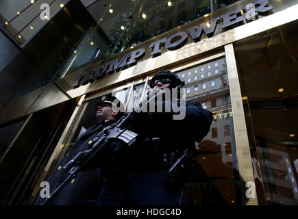New York, USA. 12th Dec, 2016. An armed NYPD police officer stands guard outside the entrance to Trump Tower on December 11, 2016 in New York City. U.S. President-elect Donald Trump is still holding meetings upstairs at Trump Tower as he continues to fill in key positions in his new administration. Credit: John Angelillo/ Pool via CNP /MediaPunch Credit:  MediaPunch Inc/Alamy Live News Stock Photo
