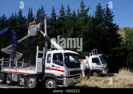 Men working on power lines in New Zealand. Stock Photo