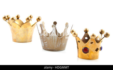 Three golden crowns in a row over white Stock Photo