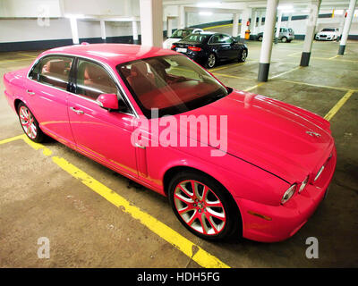 This image features the iconic Pink Panther Jaguar, a sleek and powerful car known for its design and performance. The photo highlights its aerodynamic shape and distinctive color, symbolizing luxury and style. Stock Photo