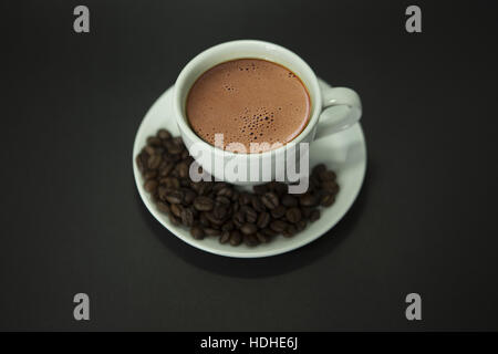 Top view, coffee cup and coffee beans on black background. Stock Photo